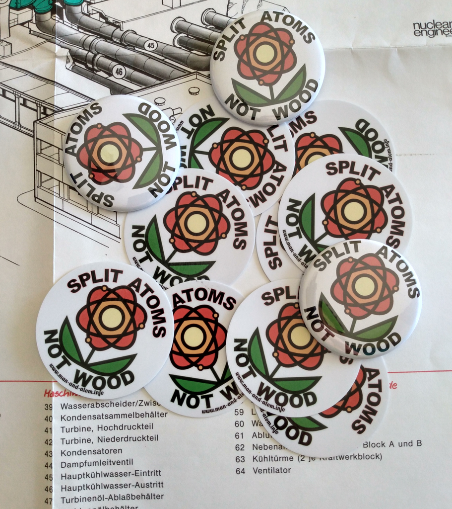 Badges and stickers with an "atomic flower" logo and the motto "Split Atoms Not Wood"