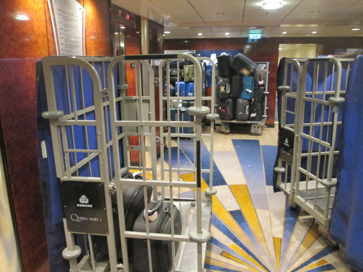 Passenger baggage stacked on carts in an elevator lobby of the Cunard QUEEN MARY 2